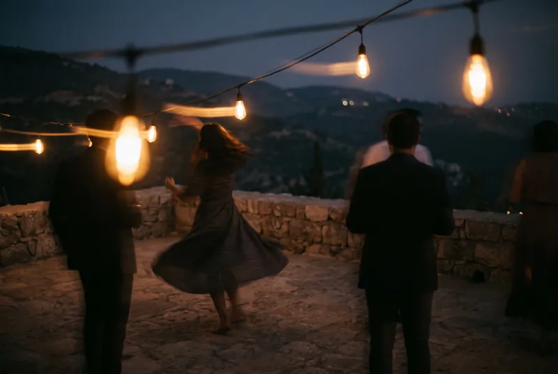 Dancing on the terrace under string lights.